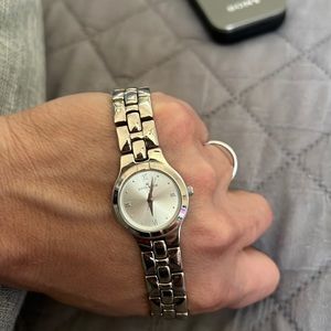 Ann Klein watch with a white round face.
